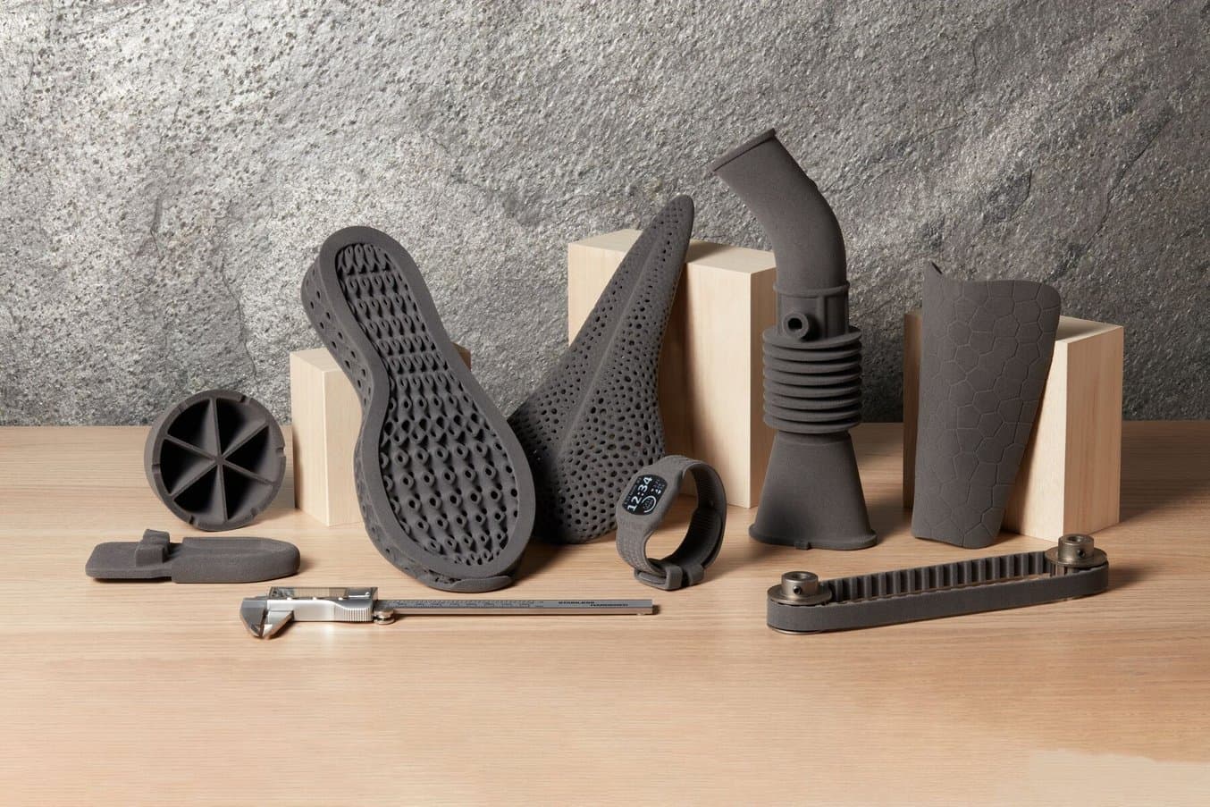 TPU 90A samples, including insoles, a toothed belt and bellows, on a wooden table