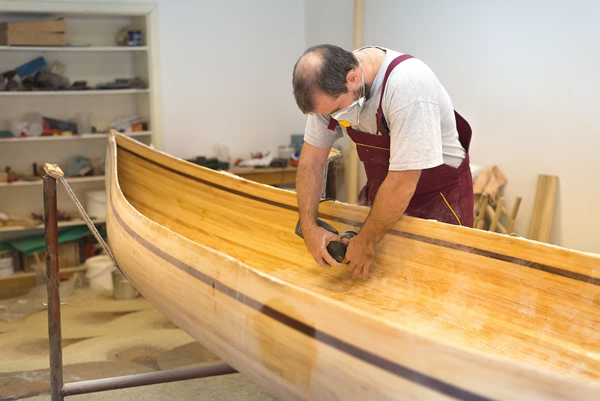 Boatbuilder working on a wooden hull
