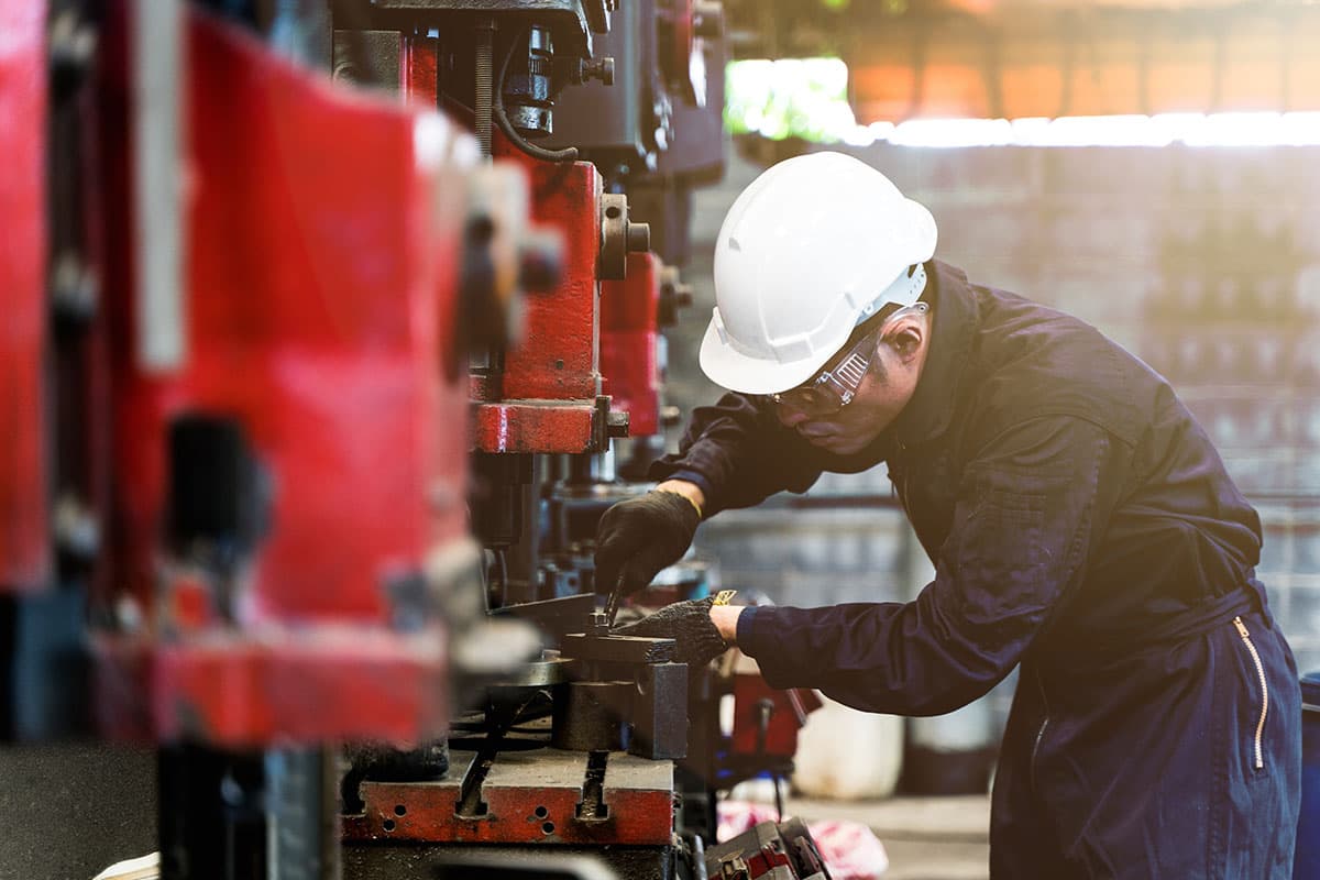 Technician servicing a machine in an industrial plant