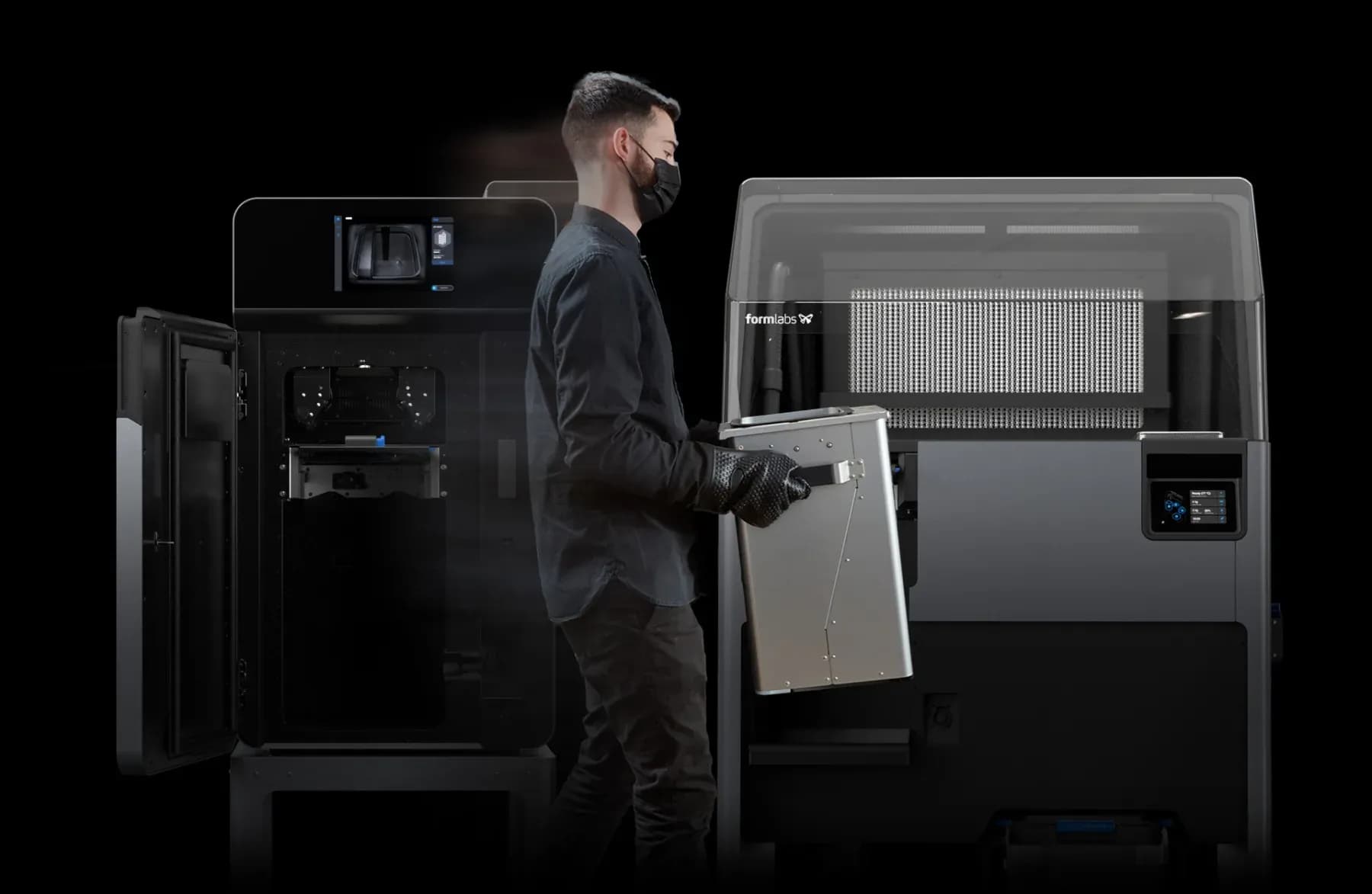 Operator handling the build chamber of a Fuse 1+ 30W printer.